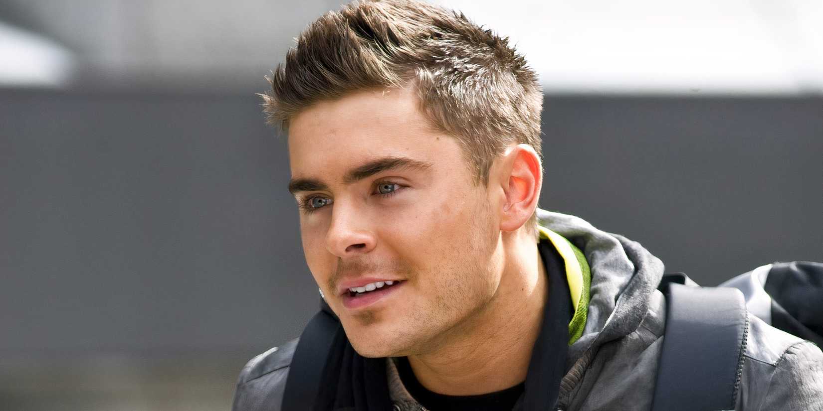 Zac Efron as Paul looking happy in New Year's Eve.