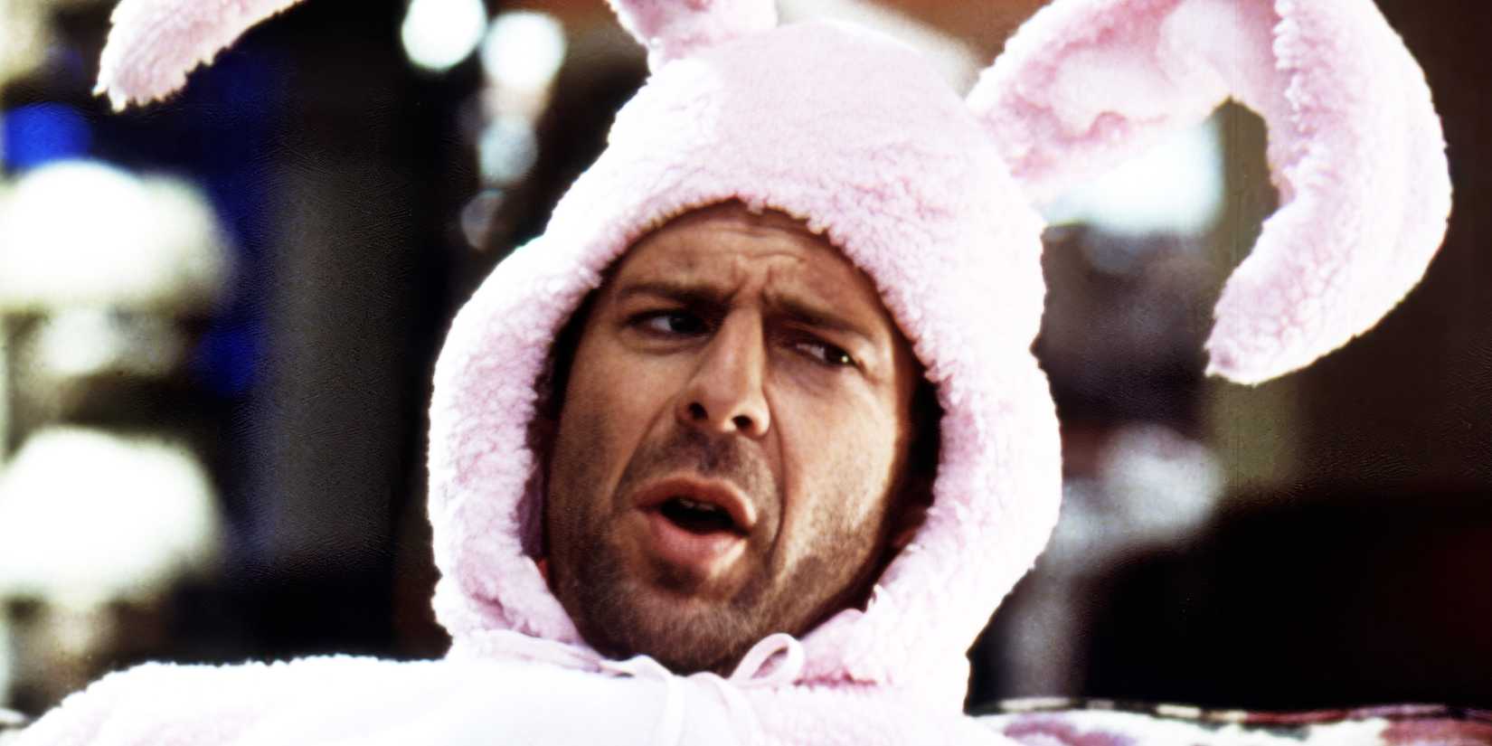 Close-up of Narrator in a pink bunny suit, talking to someone off camera.