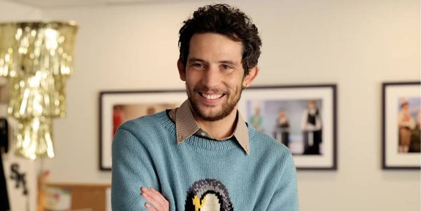 Josh O'Connor wearing a blue penguin sweater in a promo for SNL.