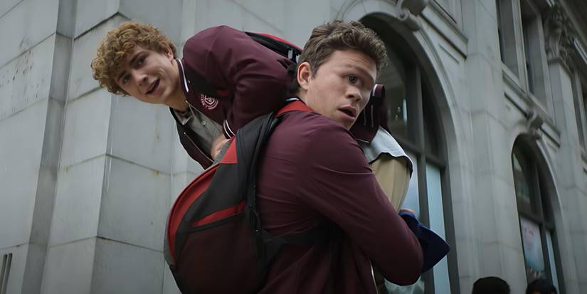 Tyson (Daniel Diemer) holds Percy (Walker Scobell) over his shoulder in Percy Jackson and the Olympians Season 2.