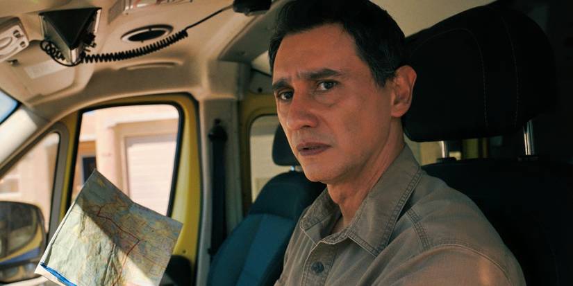 Carlos-Manuel Vesga with a map looking worried in the Pluribus finale.