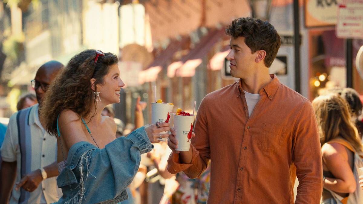 Emily Bader and Tom Blyth enjoying sweet drinks while walking the streets in People We Meet on Vacation