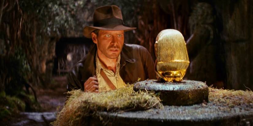 Indiana Jones thinking about seizing a gold statue in the opening of Raiders of the Lost Ark (1981)