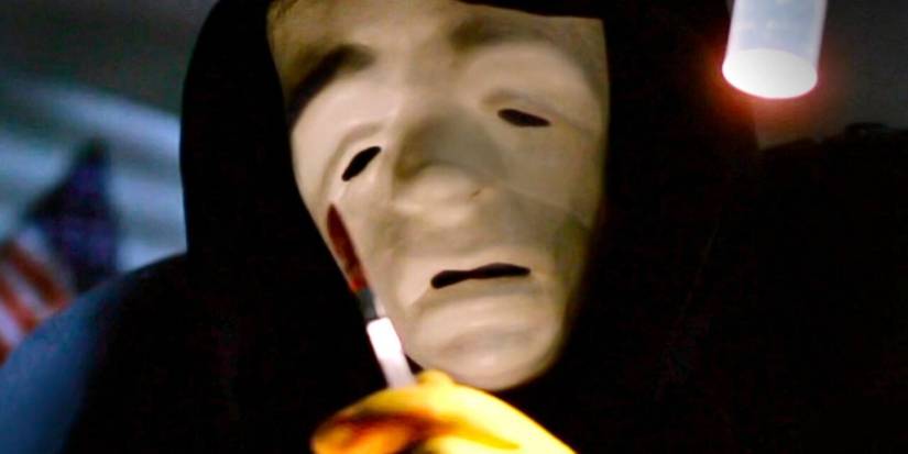 The masked killer is holding a bloody scalpel in 