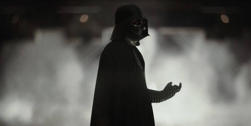 Darth Vader standing against a shadowy, fog-filled backdrop in Rogue One: A Star Wars Story