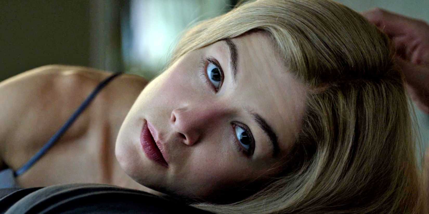 Rosamund Pike as Amy looks up from a lying position in Gone Girl.