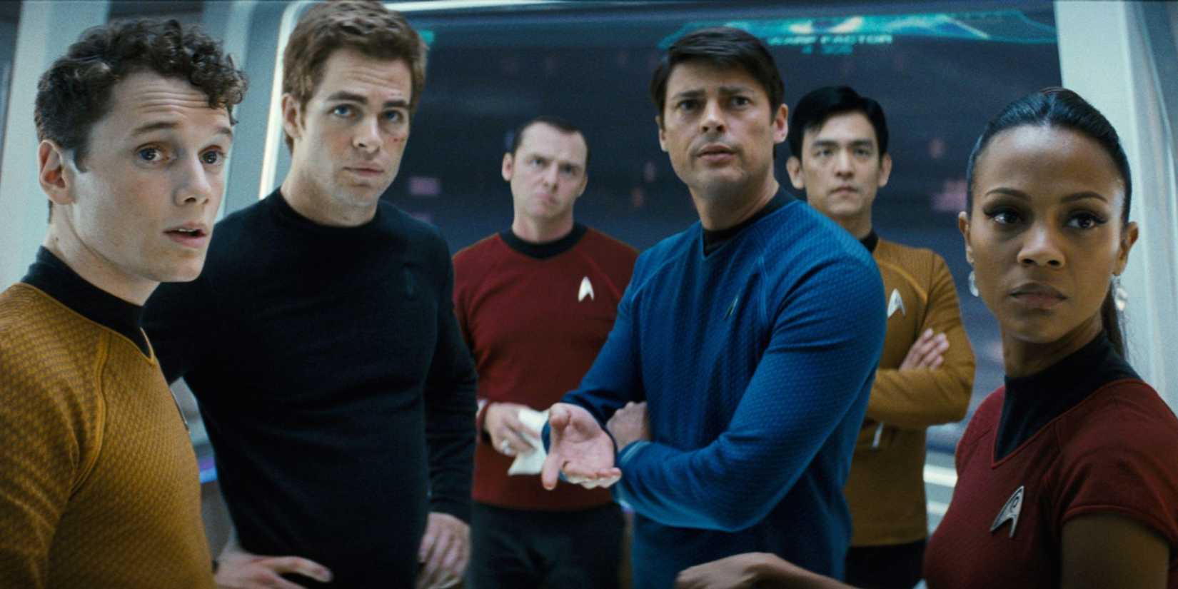 Chris Pine, Zachary Quinto, Zoe Saldaña, and the cast look anxious on the bridge in Star Trek, 2009.