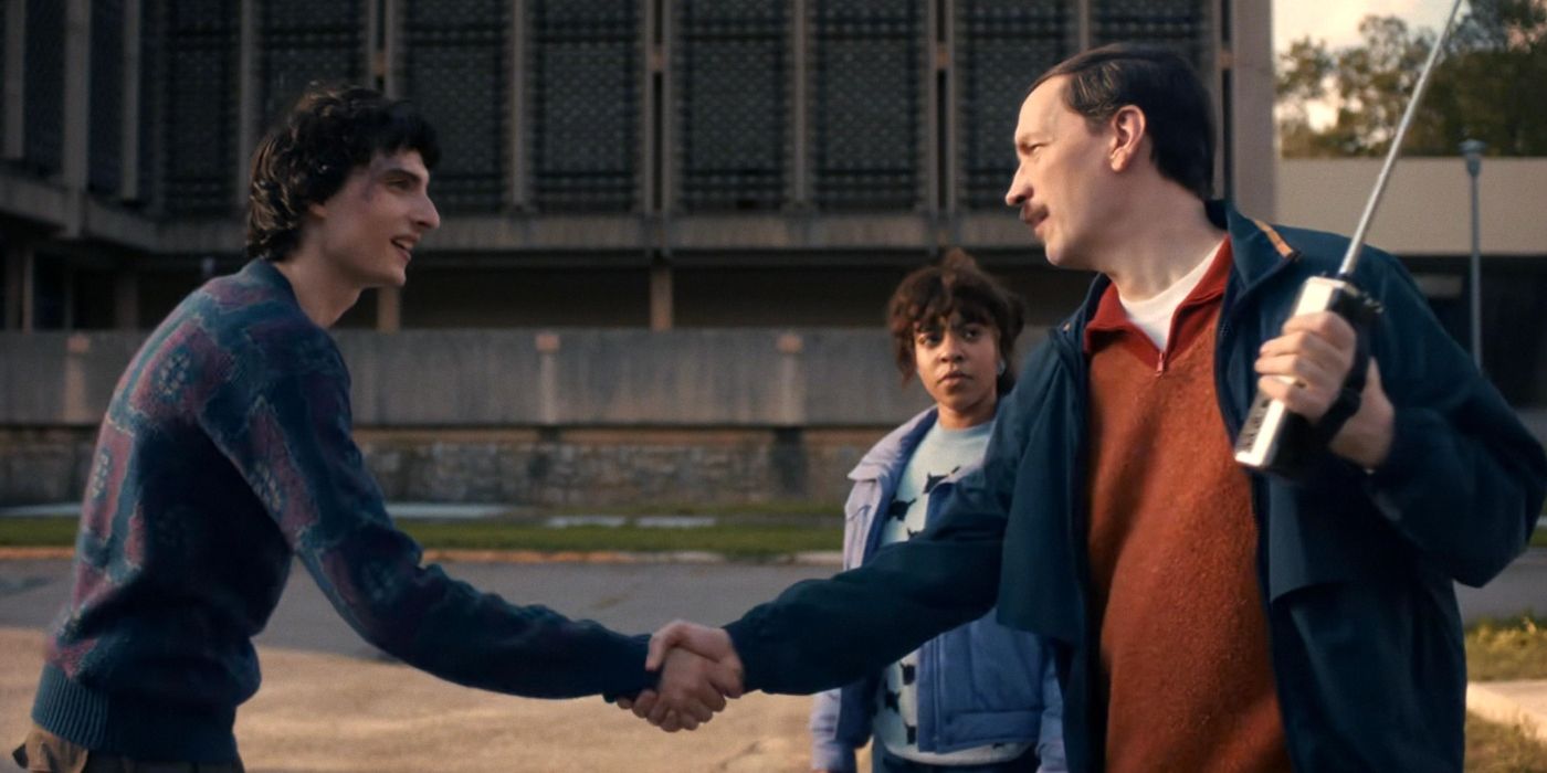 Mike (Finn Wolfhard) shakes hands with Mr. Clarke (Randy Havens) in Stranger Things Season 5