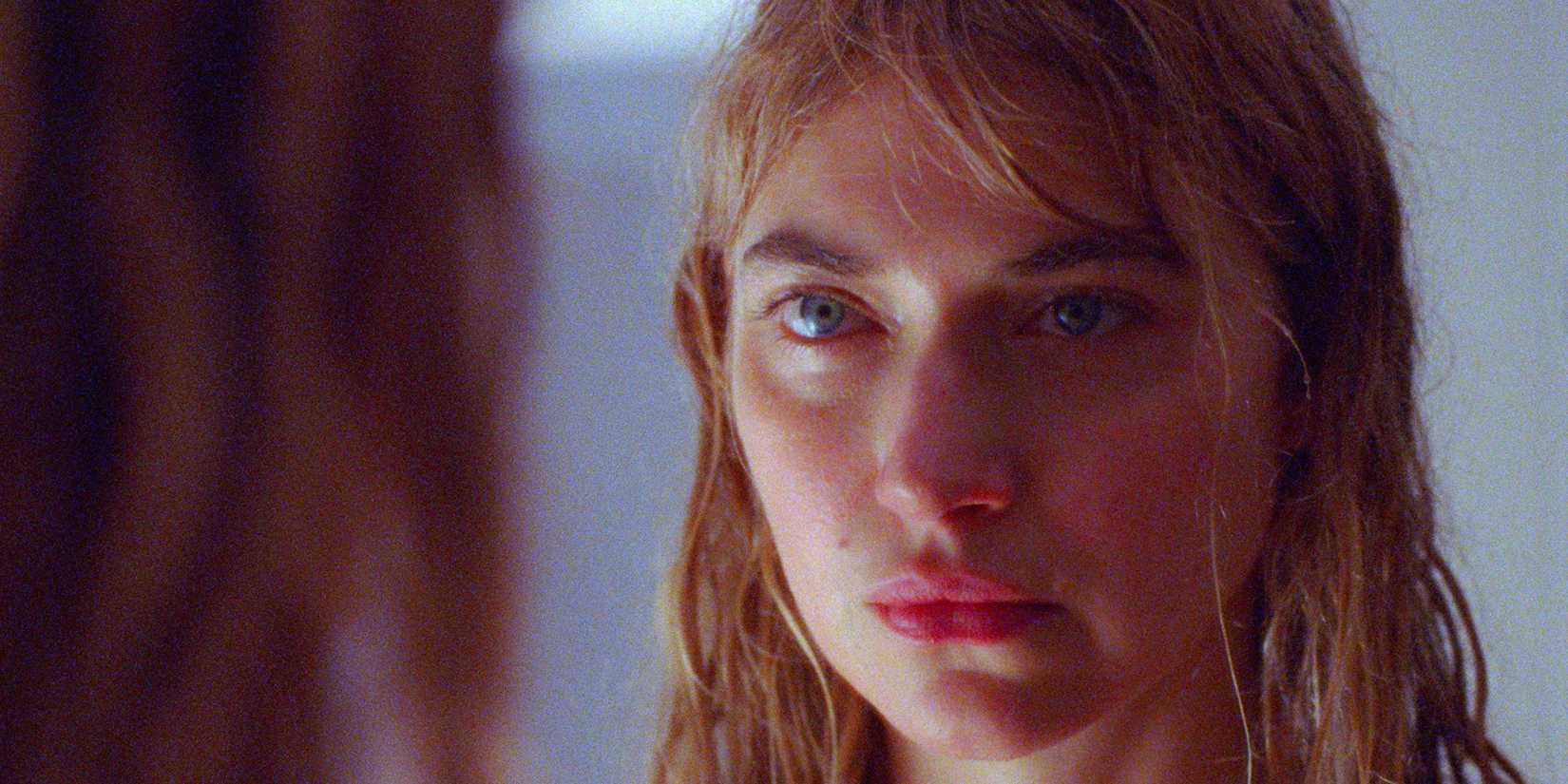 Imogen Poots as Lidia looking sad and serious in The Chronology of Water