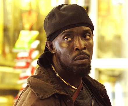 Michael K Williams looking to the side with a serious expression in The Wire.