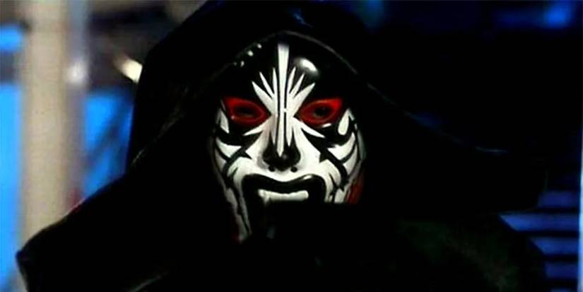 A hooded person in a white and black mask with red eye windows in The Masked Prosecutor.