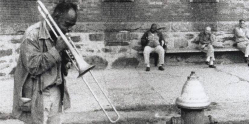 A man playing the trumpet on the street in Titicut Follies