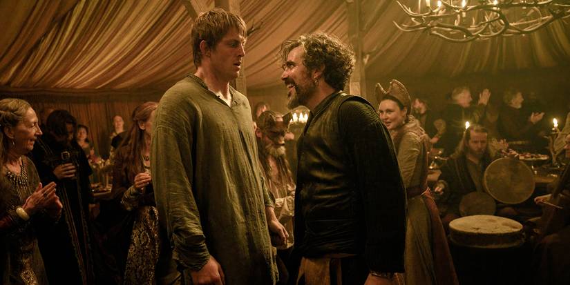 Peter Claffey as Dunk with Daniel Ings as Lyonel Baratheon at a party dancing in A Knight of the Seven Kingdoms Season 1