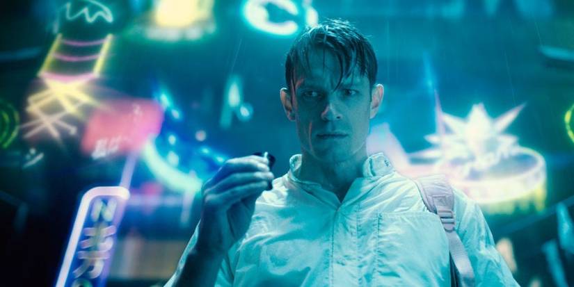 Joel Kinnaman readies himself to do drugs in a neon-lit alley in Netflix's 'Altered Carbon'