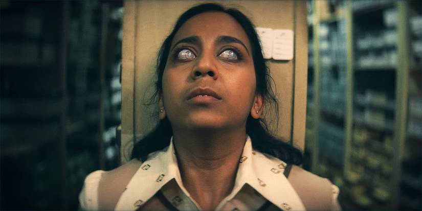 Anjana Vasan looks to the side with hazy eyes in Black Mirror