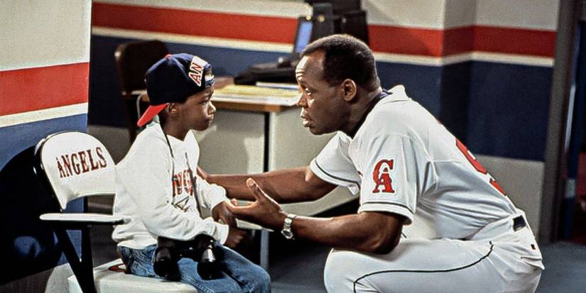 Danny Glover as coach George Knox talking to a young Milton Davis Jr. as J.P. in a locker room in Angels in the Outfield