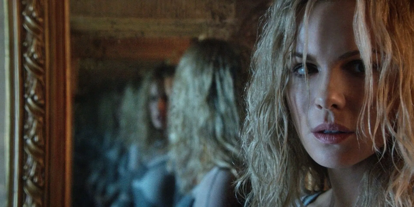 A woman looks at her multiple reflections in the mirror