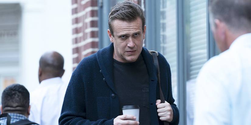 Jason Segel looking annoyed holding coffee in Dispatches From Elsewhere