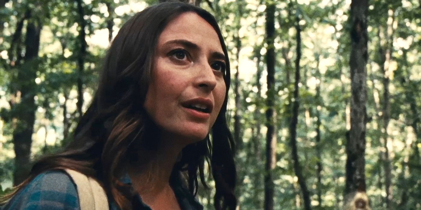 Fabianne Therese looks off camera at something in the woods in 'Dolly' image