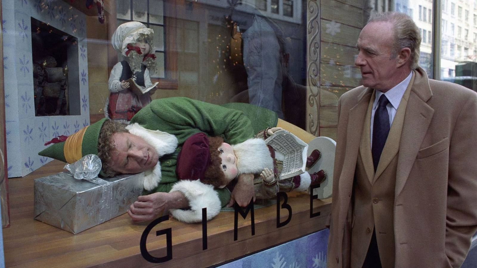 Will Ferrell as Buddy sleeps in a department store window as James Caan as Walter walks by in Elf.