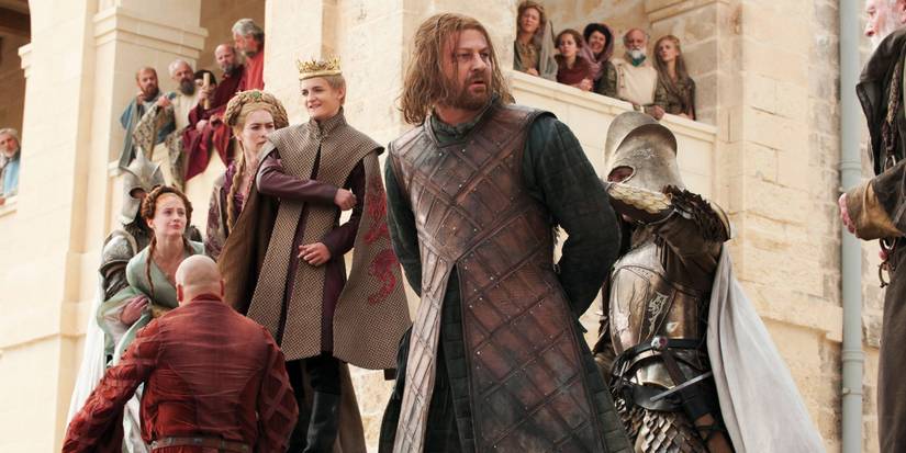 Ned taken away in handcuffs as others look on in Game of Thrones.