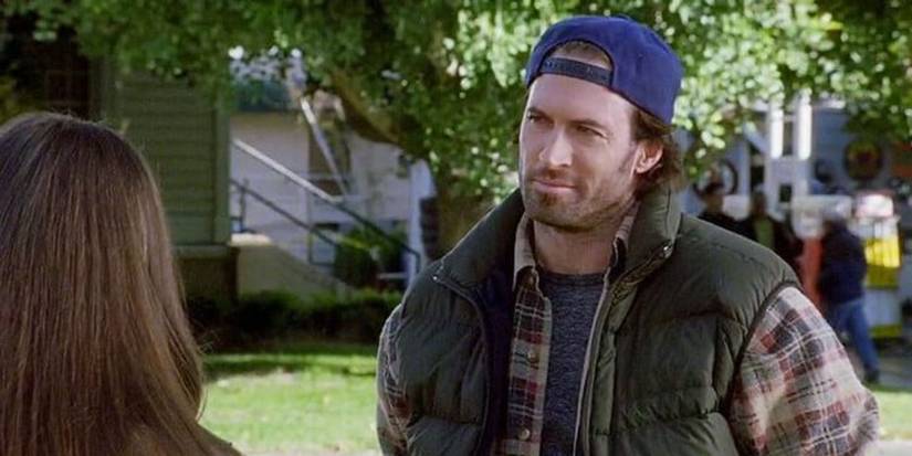 Scott Patterson as Luke Danes standing outside and looking at someone with their back to the camera in 'Gilmore Girls'.