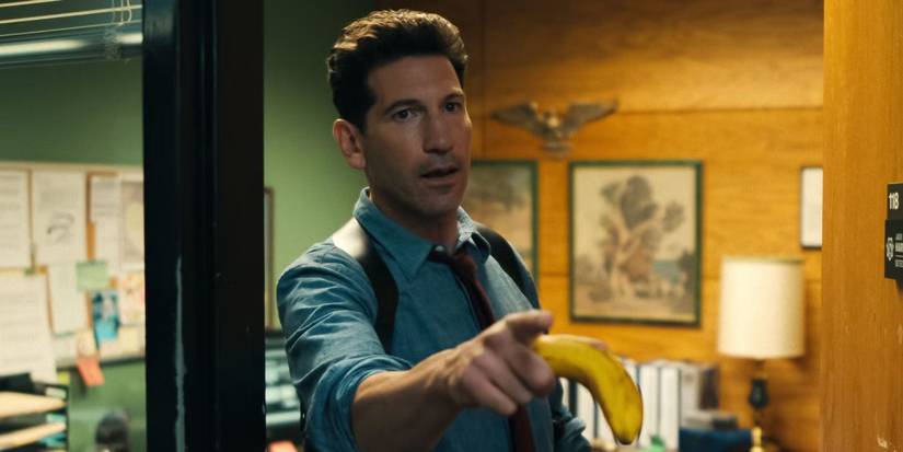 Jon Bernthal holding a banana and pointing in 'His & Hers'.