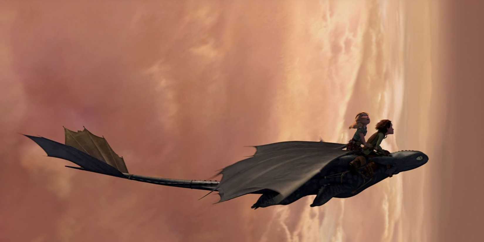 Astrid and Hiccup ride Toothless, a black dragon, through sunset clouds in How to Train Your Dragon, 2010.