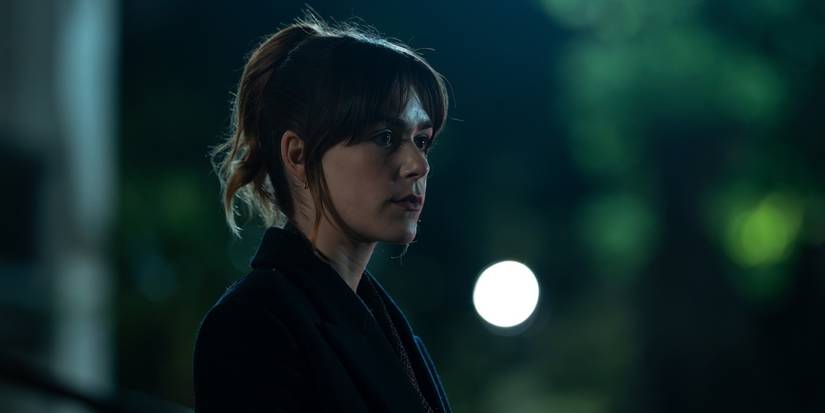 Kiernan Shipka as Hayley Clay standing outside and looking serious in Industry Season 4