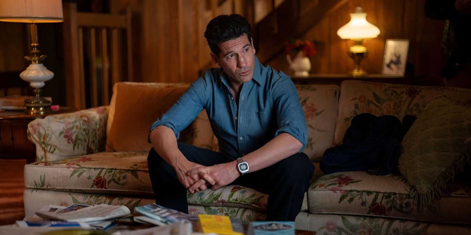 Jon Bernthal sitting on a couch looking worried in His & Hers.
