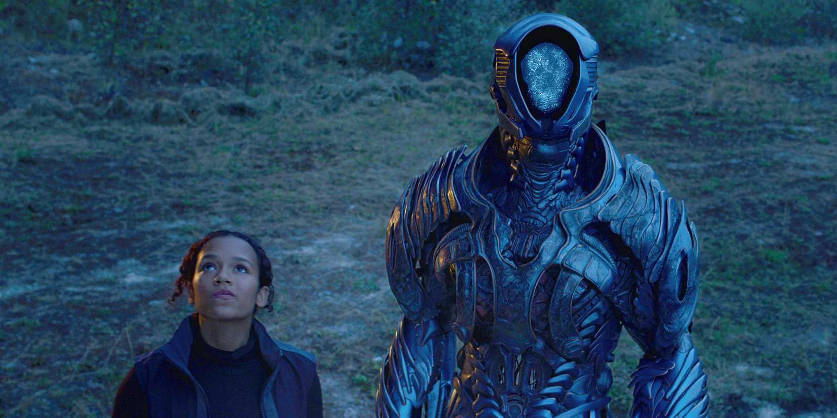 Judy Robinson (Taylor Russell) and the Robot (Brian Steele) are seen looking up in Netflix's Lost in Space