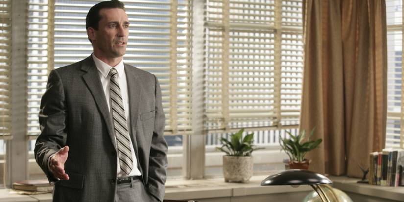 Jon Hamm as Don Draper talking to someone off-screen in an office in the pilot of 'Mad Men.'