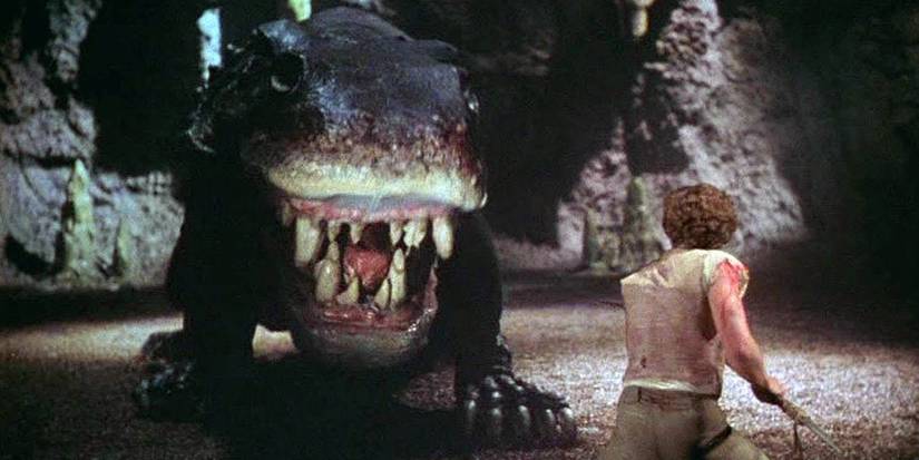 Man facing monster in 'At the Earth's Core' (1976)