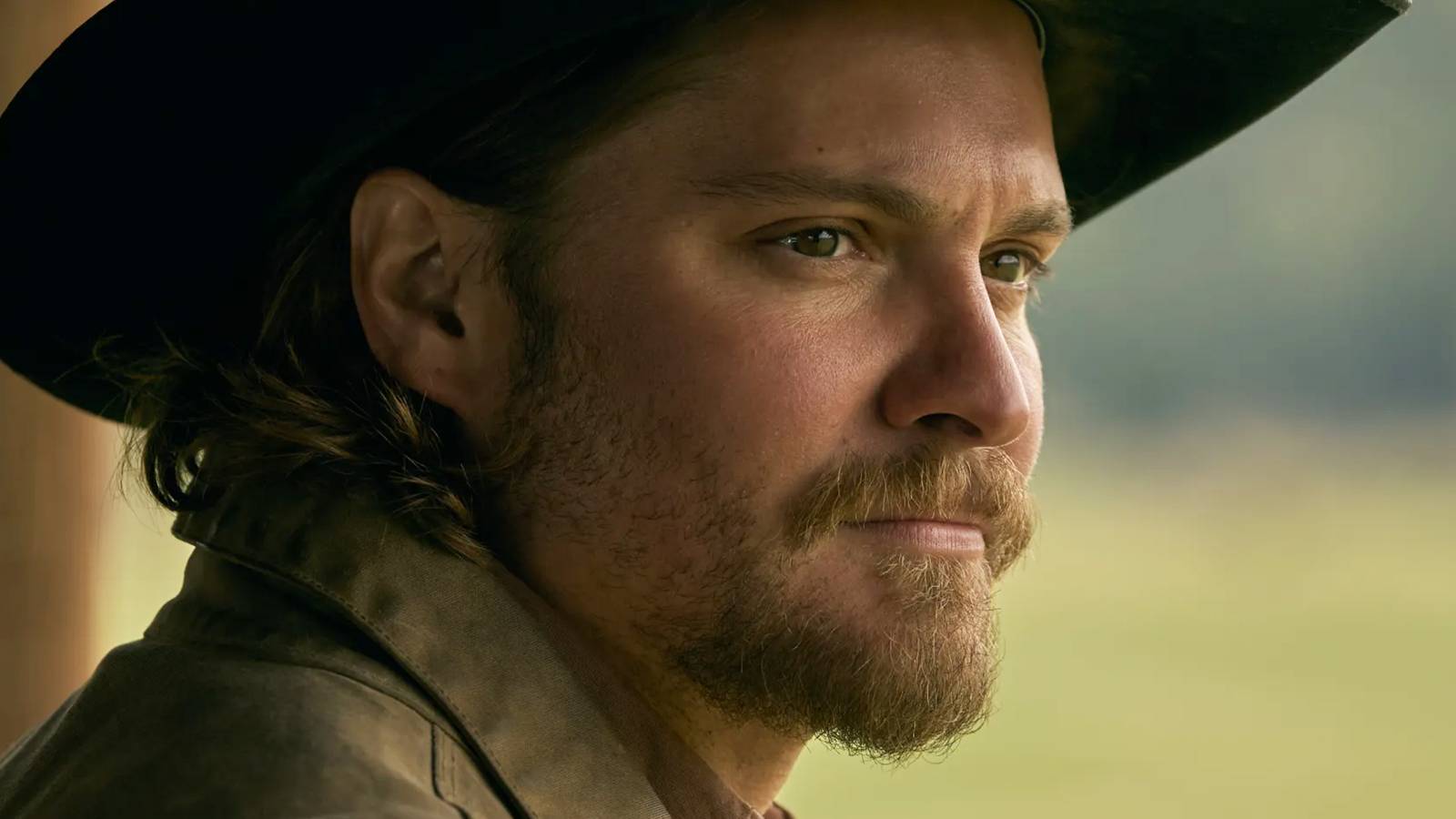 Luke Grimes' Kayce Dutton looking off into the distance on Marshals