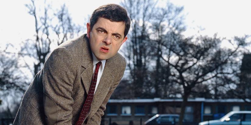 Mr. Bean (Rowan Atkinson) hunched over in Mr. Bean.