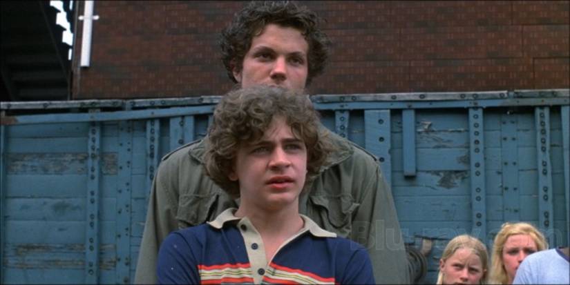 A young man with another man behind him in My Bodyguard