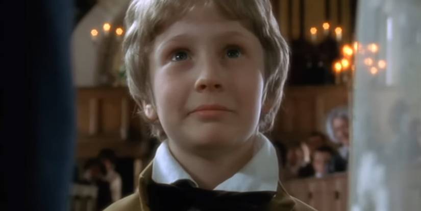 Oliver Twist (Sam Smith) looks up at his aunt's wedding in 'Oliver Twist' (1999)