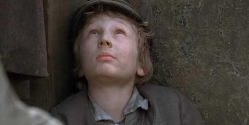 Oliver Twist (Sam Smith) looks up on the streets in 'Oliver Twist' (1999)