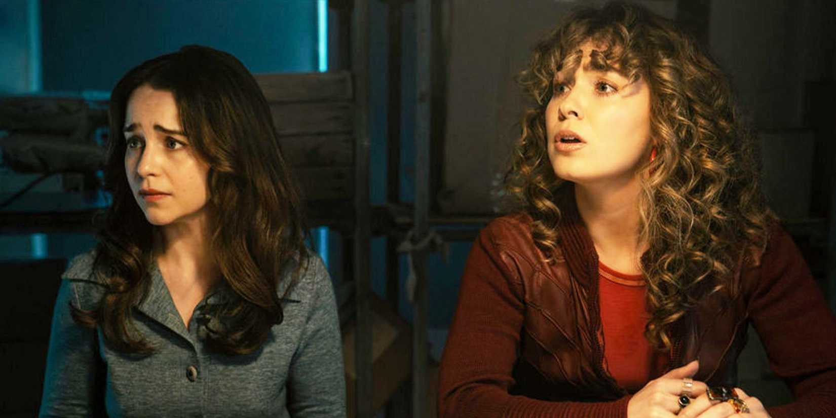 Emilia Clarke as Beatrice and Haley Lu Richardson as Twila sitting and looking to the side with angst in Ponies.