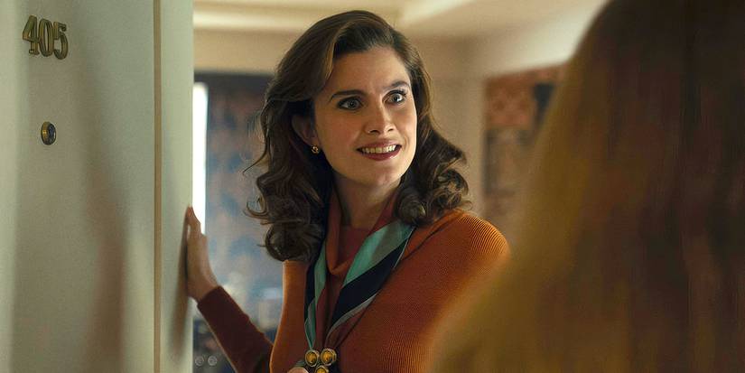 Vic Michaelis as Cheryl opening the door of her home and looking at someone on the other side in Ponies