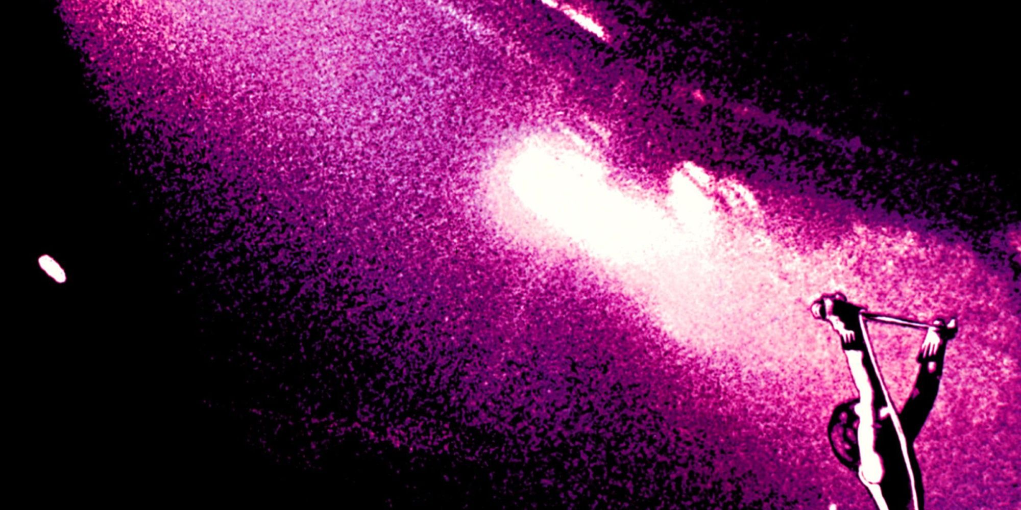 freddie-mercury-holding-mic-stand-with-bright-light-shooting-out-behind