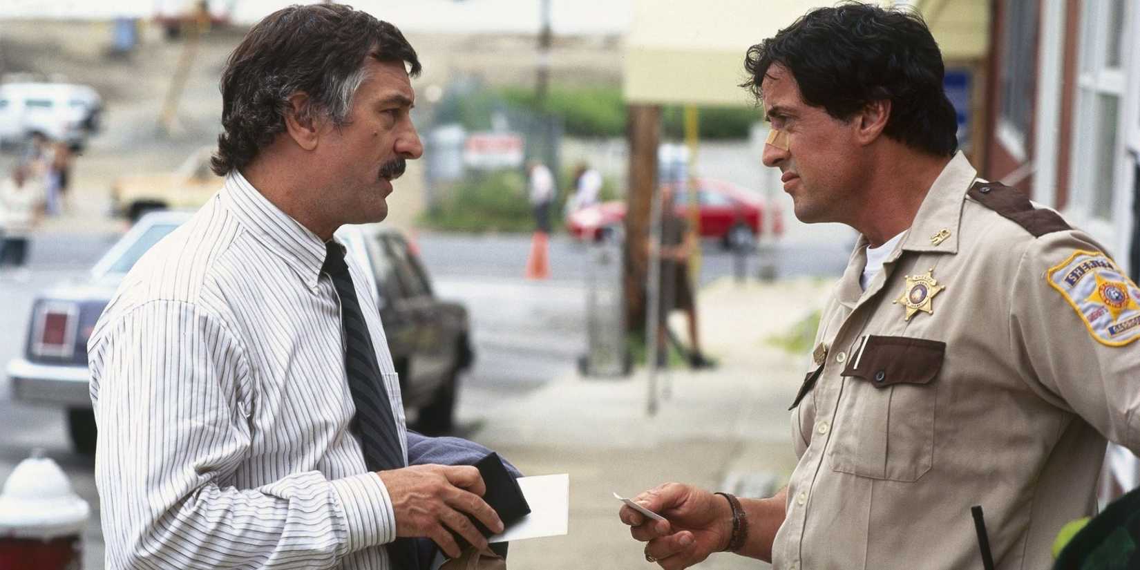 Robert De Niro talking to Sylvester Stallone who is in a sheriff's uniform in Cop Land.