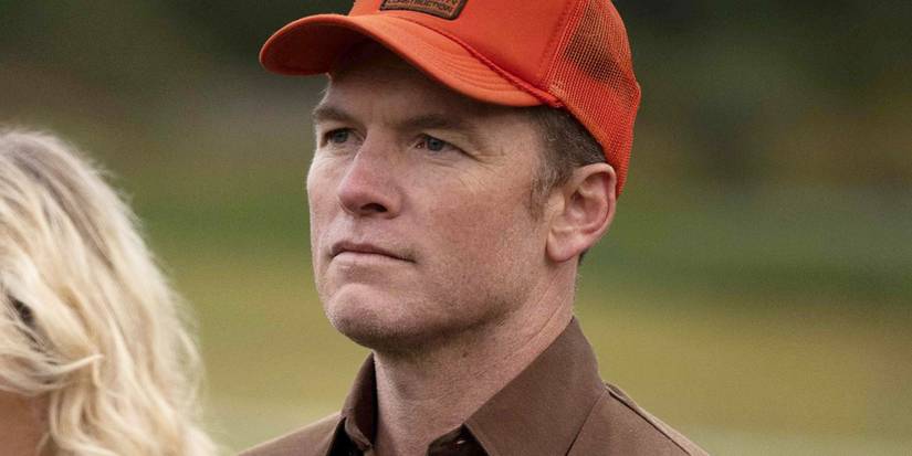 Ron Lafferty in an orange baseball cap in 'Under the Banner of Heaven'