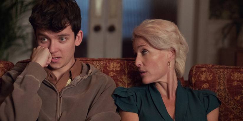 Asa Butterfield as Otis and Gillian Anderson as Jean on the couch on 'Sex Education.'