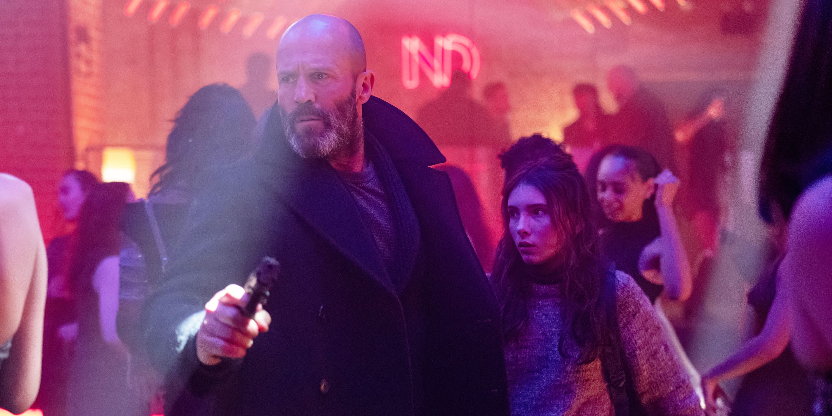 Jason Statham as Mason guiding Bodhi Rae Breathnach's Jessie through a club in Shelter.