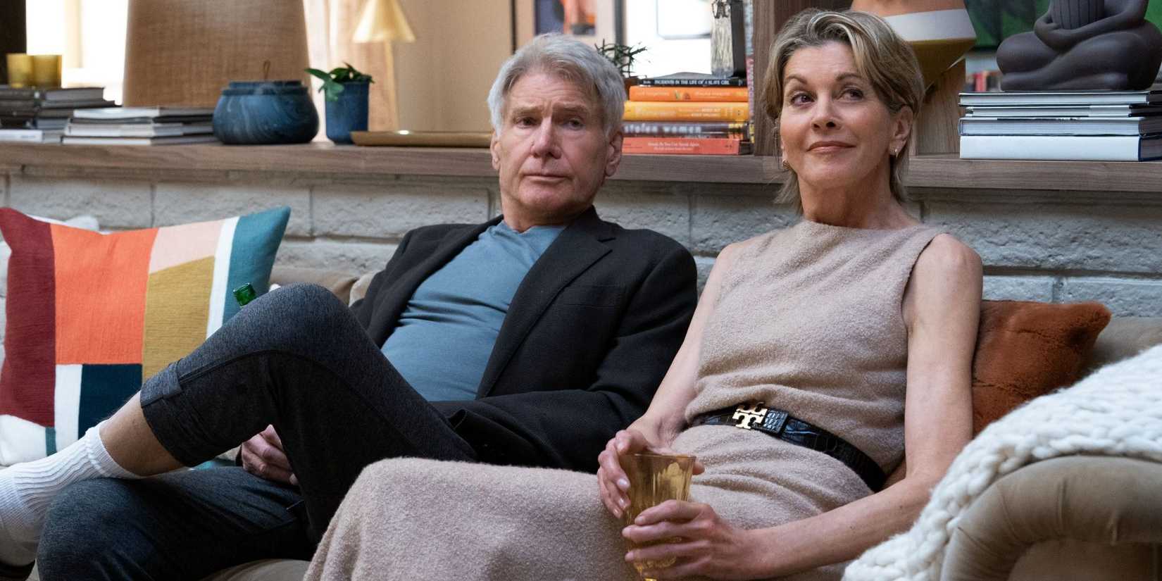 Harrison Ford as Paul sitting on the couch next to Wendie Malick on Thanksgiving in Season 2 of Shrinking.