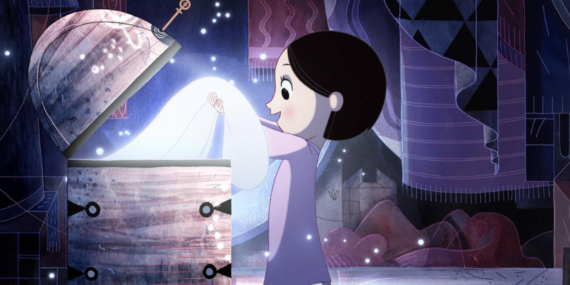 A girl opens a glowing box in a dark, magical room in Song of the Sea