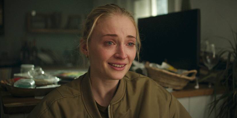 Sophie Turner as Zara smiling with tears in her eyes in Steal
