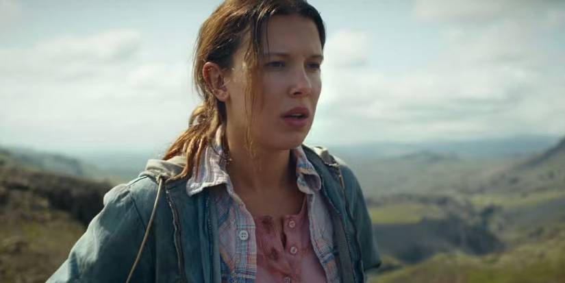 Millie Bobby Brown as Eleven outdoors looking to the distance in the series finale of 'Stranger Things'.