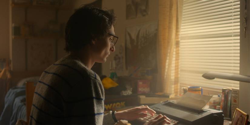 Finn Wolfhard as Mike Wheeler writes at his typewriter on 'Stranger Things.'